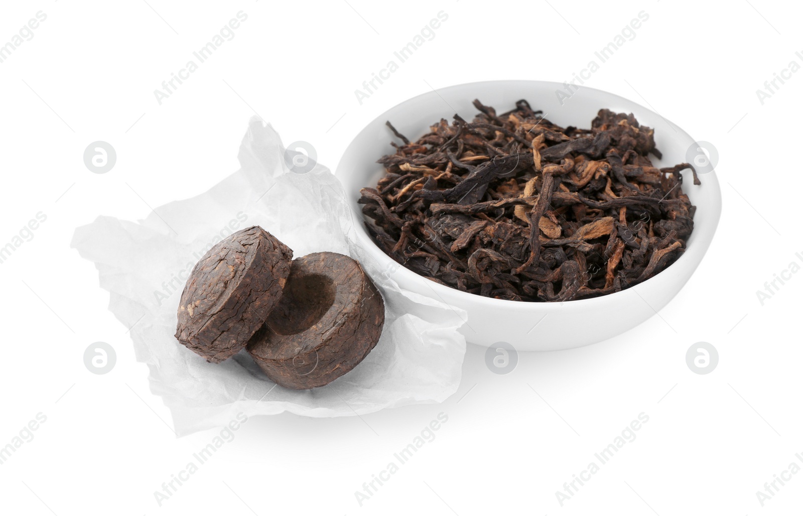 Photo of Cake shaped traditional Chinese pu-erh tea and leaves isolated on white