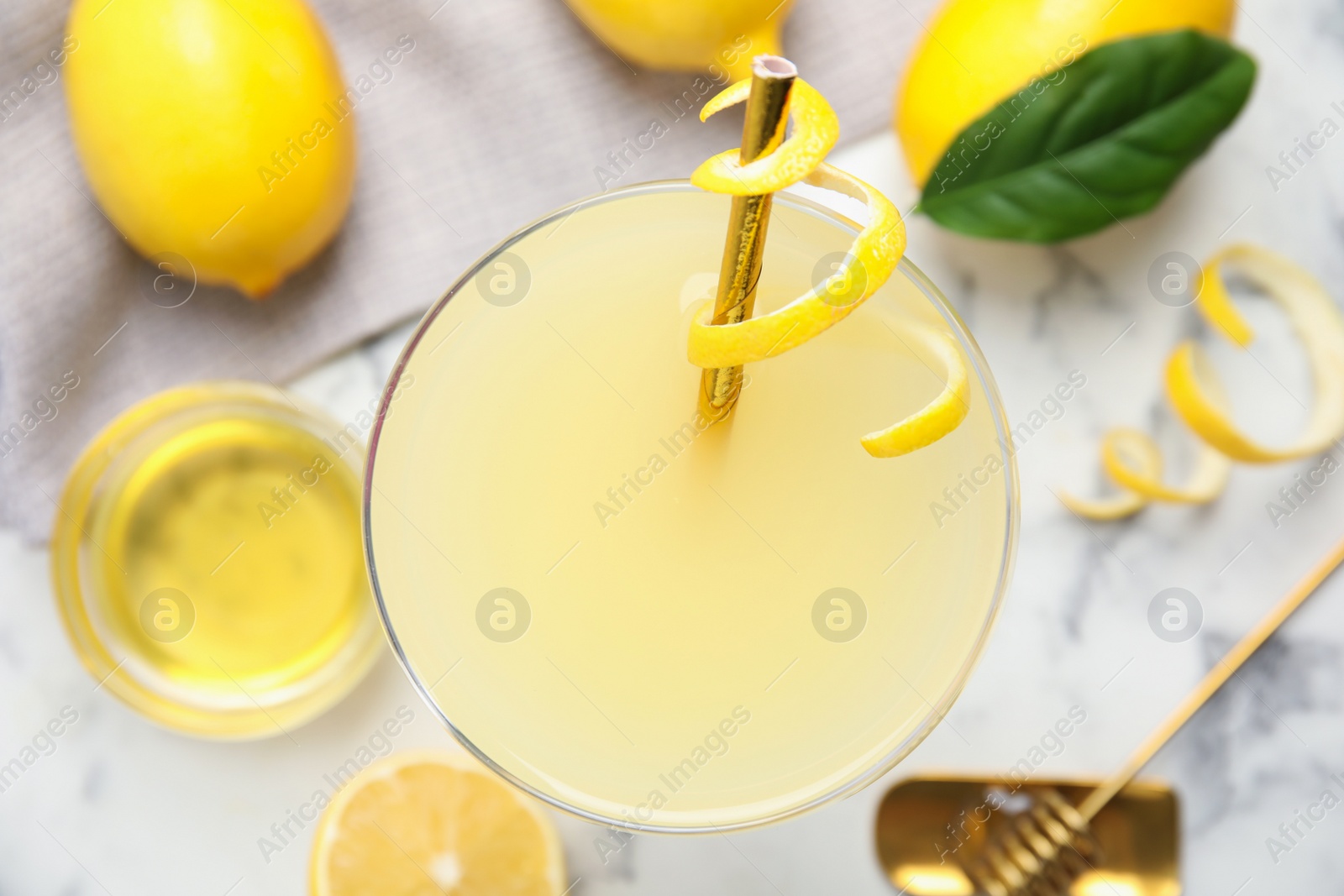 Photo of Delicious bee's knees cocktail and ingredients on white table, top view