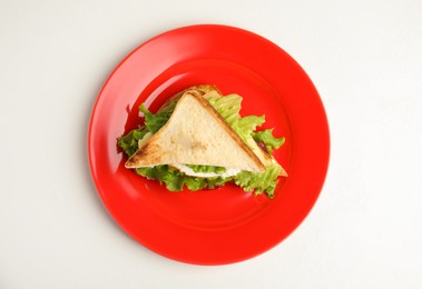 Delicious sandwich with vegetables and egg on white table, top view