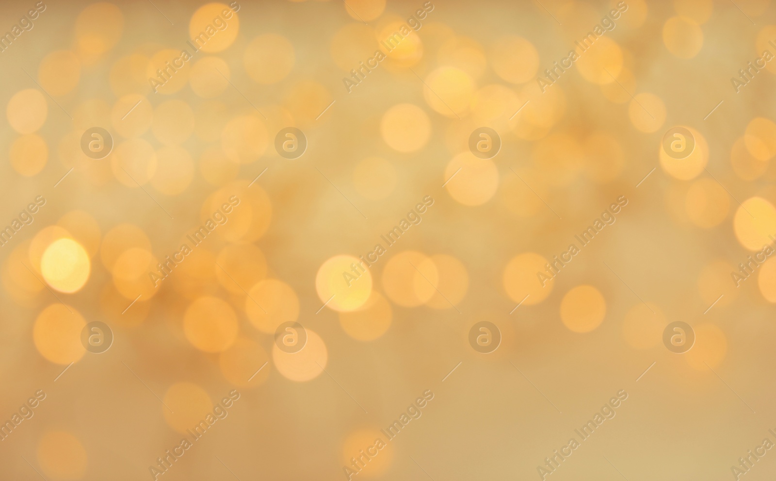 Photo of Gold glitter with bokeh effect on light background