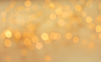 Gold glitter with bokeh effect on light background