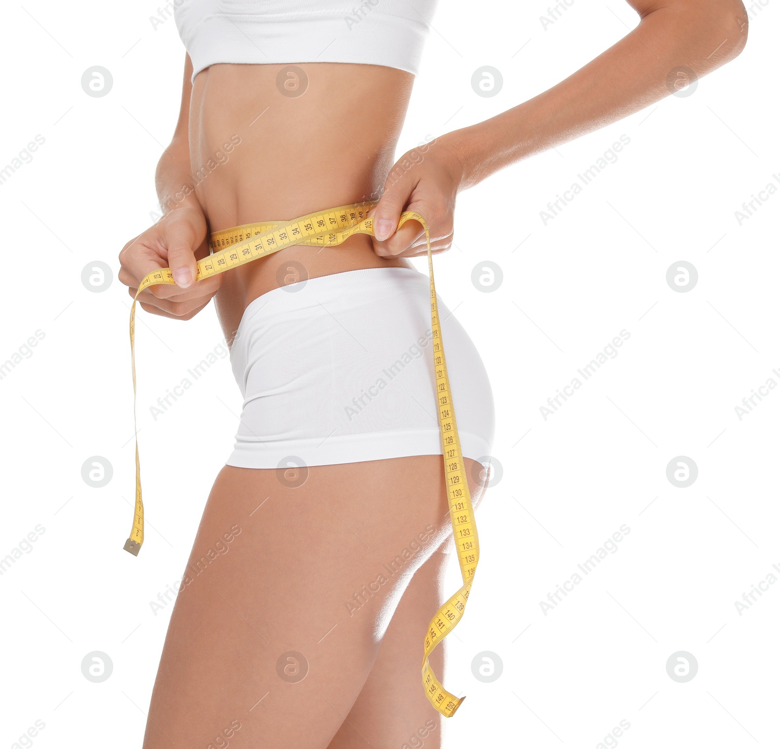 Photo of Young slim woman in underwear with measuring tape on white background. Weight loss diet