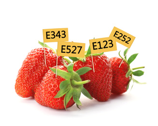 Ripe strawberries with E numbers on white background. Harmful food additives 