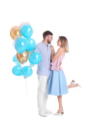 Young couple with air balloons on white background