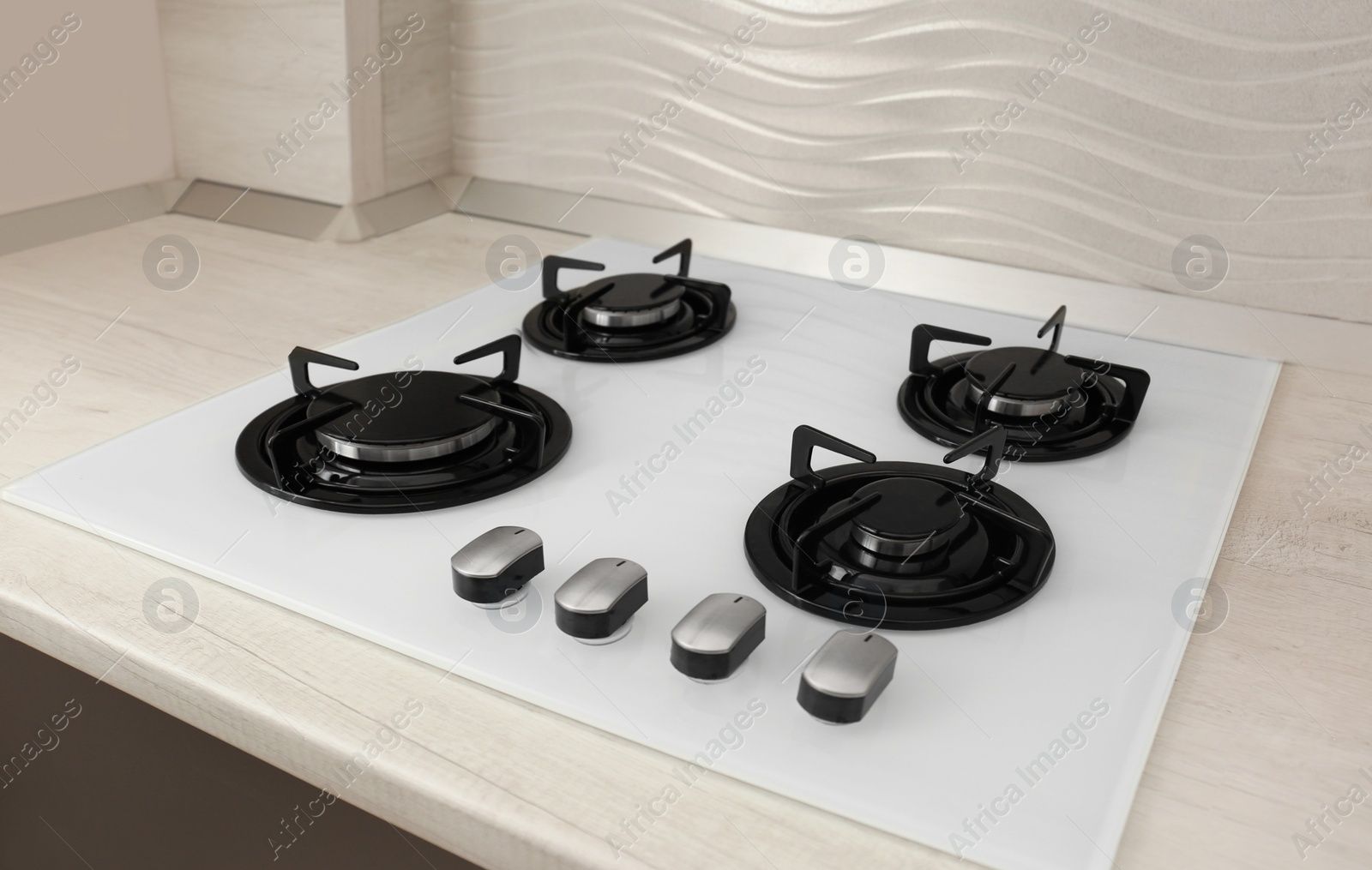 Photo of Modern built-in gas cooktop. Kitchen appliance