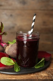Freshly made beet juice on wooden table