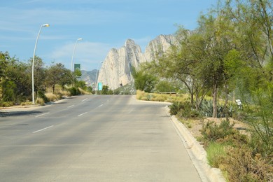 Beautiful view of asphalt road near trees in mountains