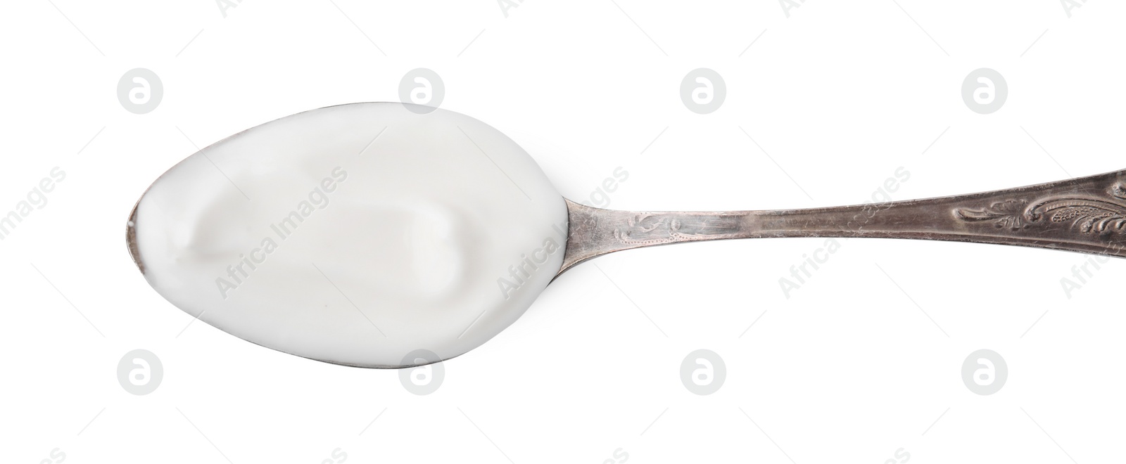 Photo of Delicious natural yogurt in spoon isolated on white, top view