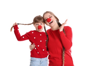 Happy woman and daughter with clown red noses on white background