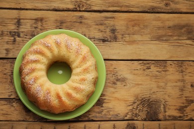 Photo of Delicious freshly baked sponge cake on wooden table, top view. Space for text