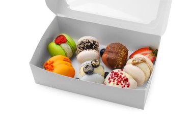 Photo of Cardboard box with delicious sweet macarons isolated on white