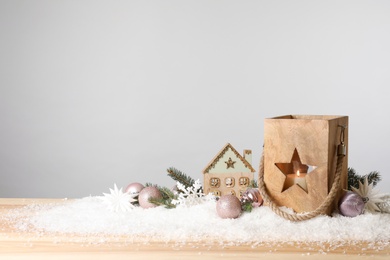 Photo of Composition with wooden Christmas lantern on table against light grey background, space for text