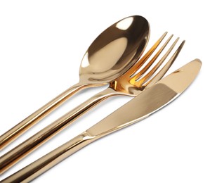 Photo of New shiny golden cutlery on white background