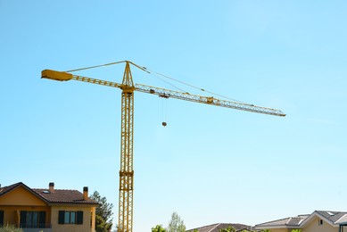 Modern construction crane outdoors on sunny day