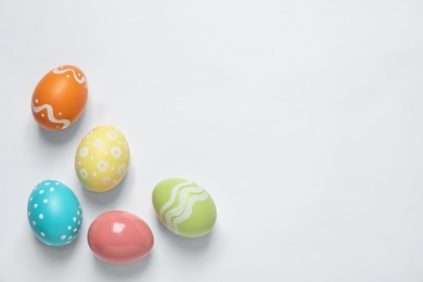 Colorful painted Easter eggs on white background, top view