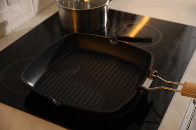 Frying pan on modern cooktop in kitchen