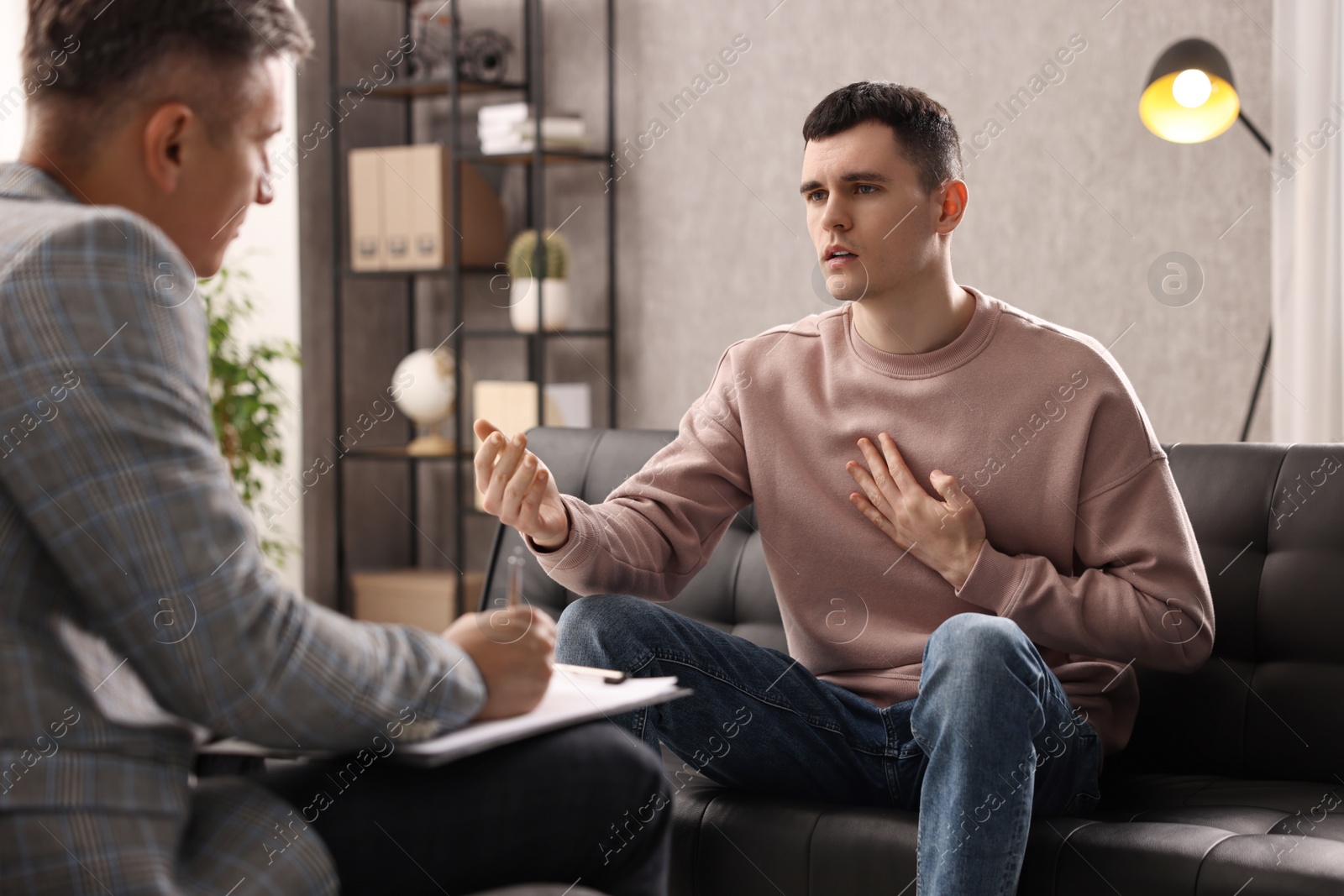 Photo of Professional psychotherapist working with patient in office