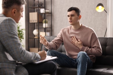 Photo of Professional psychotherapist working with patient in office