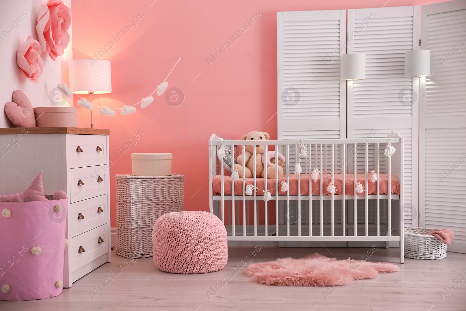 Photo of Baby room interior with decorations and comfortable crib