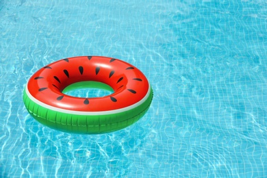 Photo of Inflatable ring floating in pool on sunny day