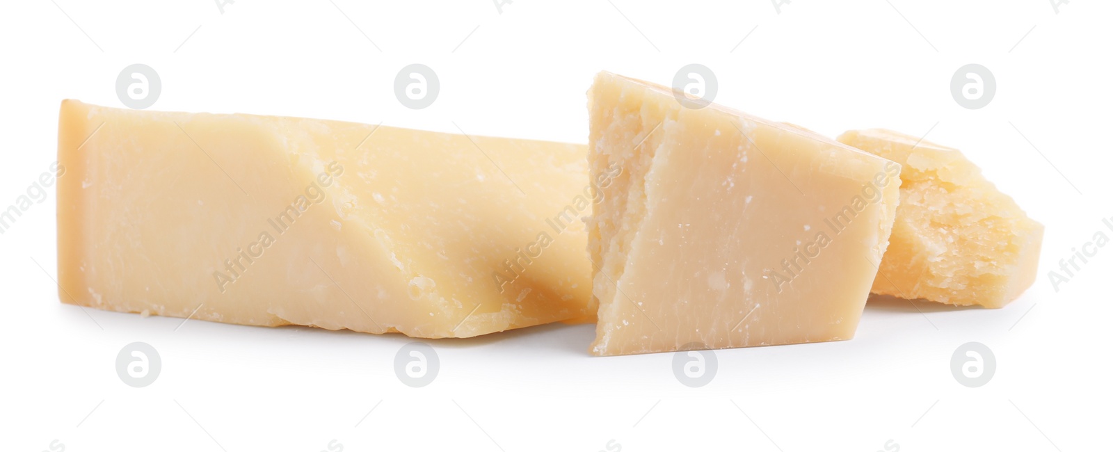 Photo of Pieces of delicious parmesan cheese on white background