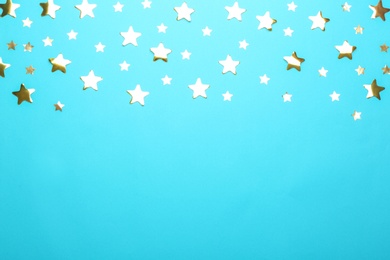 Photo of Confetti stars with space for text on blue background, top view. Christmas celebration