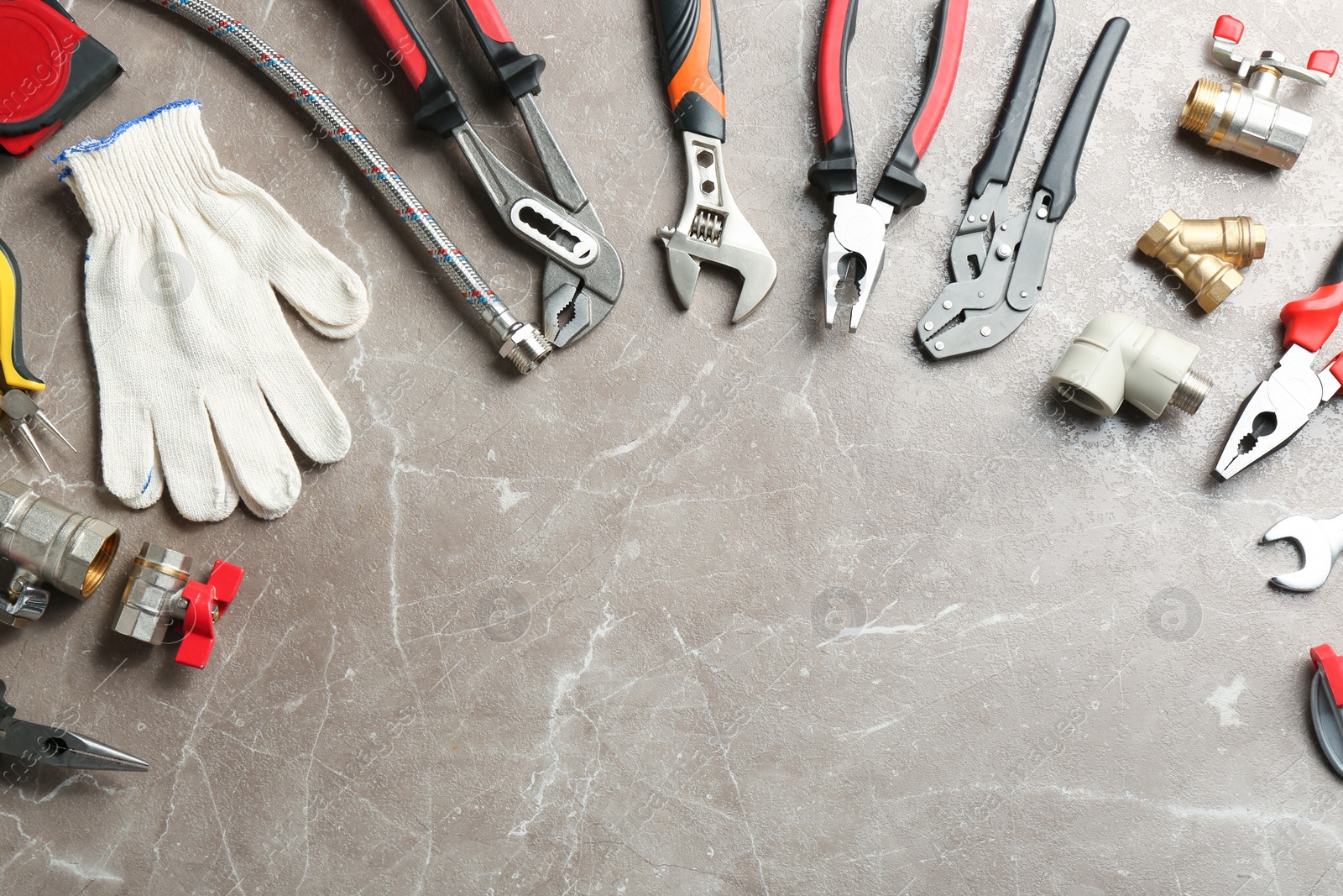 Photo of Flat lay composition with plumber's tools and space for text on grey background