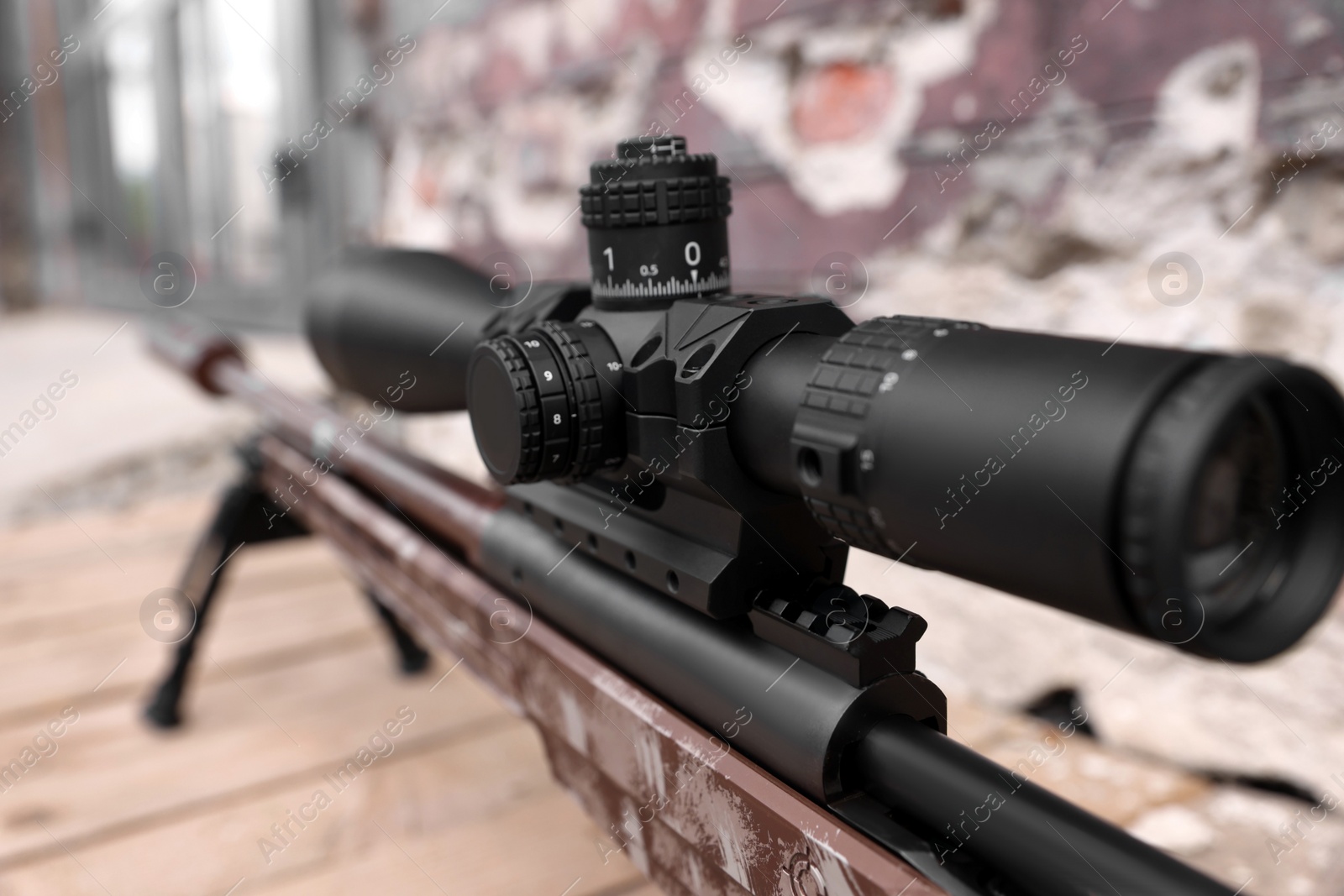 Photo of Closeup view of modern powerful sniper rifle with telescopic sight outdoors