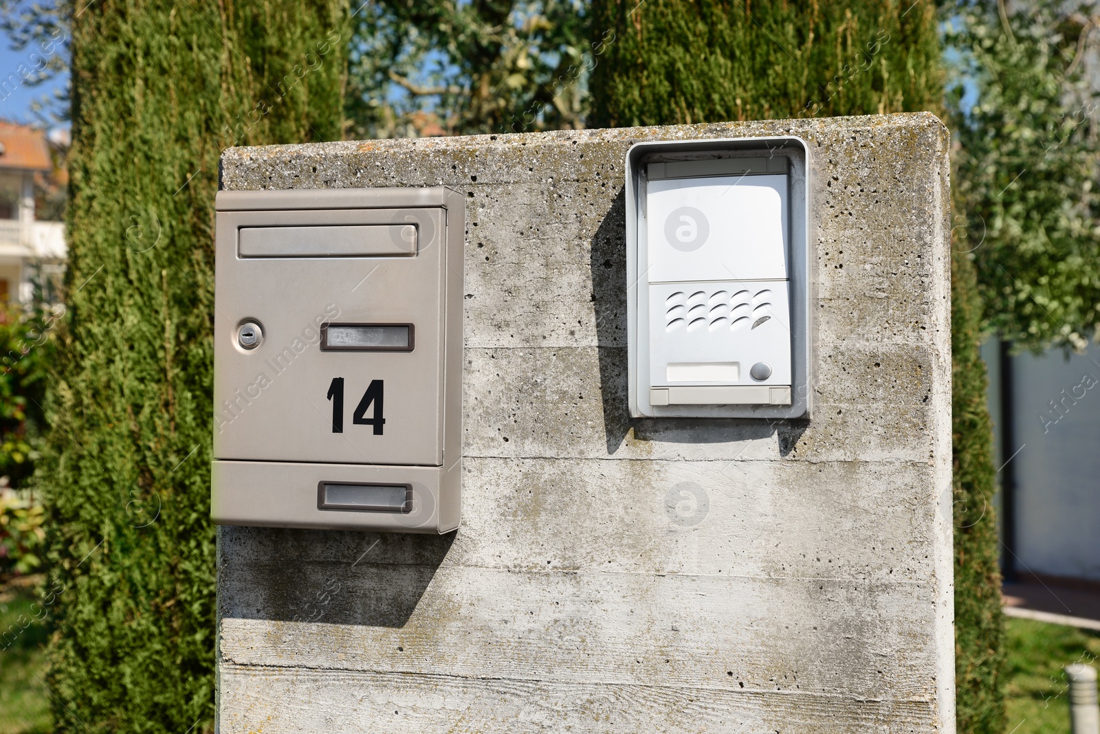 Photo of Mail box and intercom on grey concrete wall outdoors