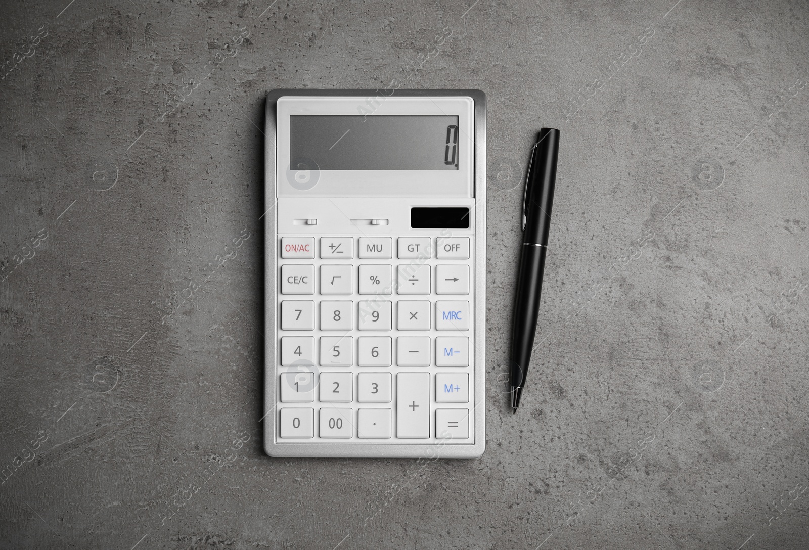 Photo of Calculator and pen on grey table, flat lay