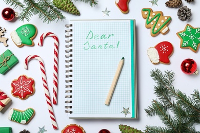 Notebook with title Dear Santa and Christmas decor on white background, flat lay