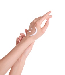 Young woman applying hand cream against on white background