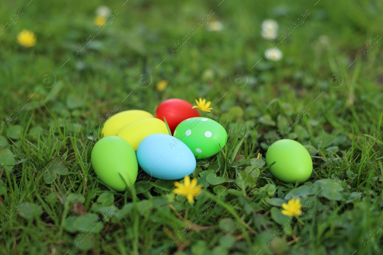 Photo of Easter celebration. Painted eggs on green grass