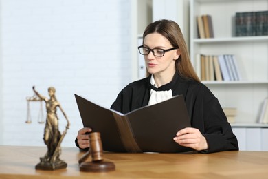Photo of Judge with folder working indoors, selective focus