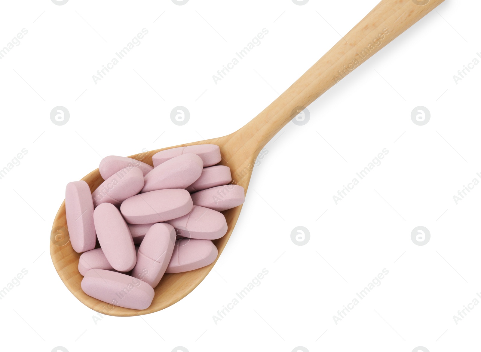 Photo of Vitamin pills in wooden spoon isolated on white, top view. Health supplement