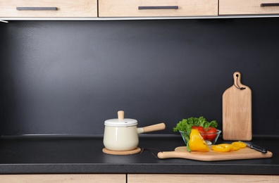 Composition with kitchenware and products on countertop. Space for text