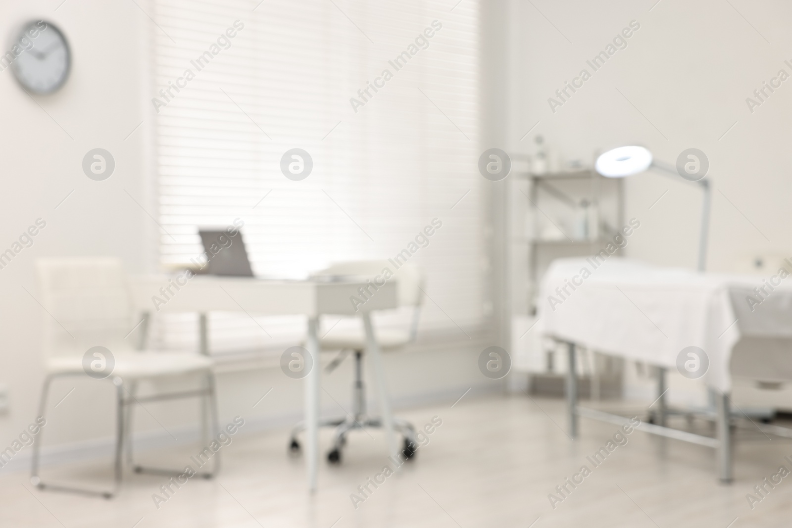 Photo of Blurred view of dermatologist's office with examination table