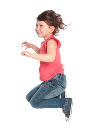 Photo of Happy little girl in casual outfit jumping on white background