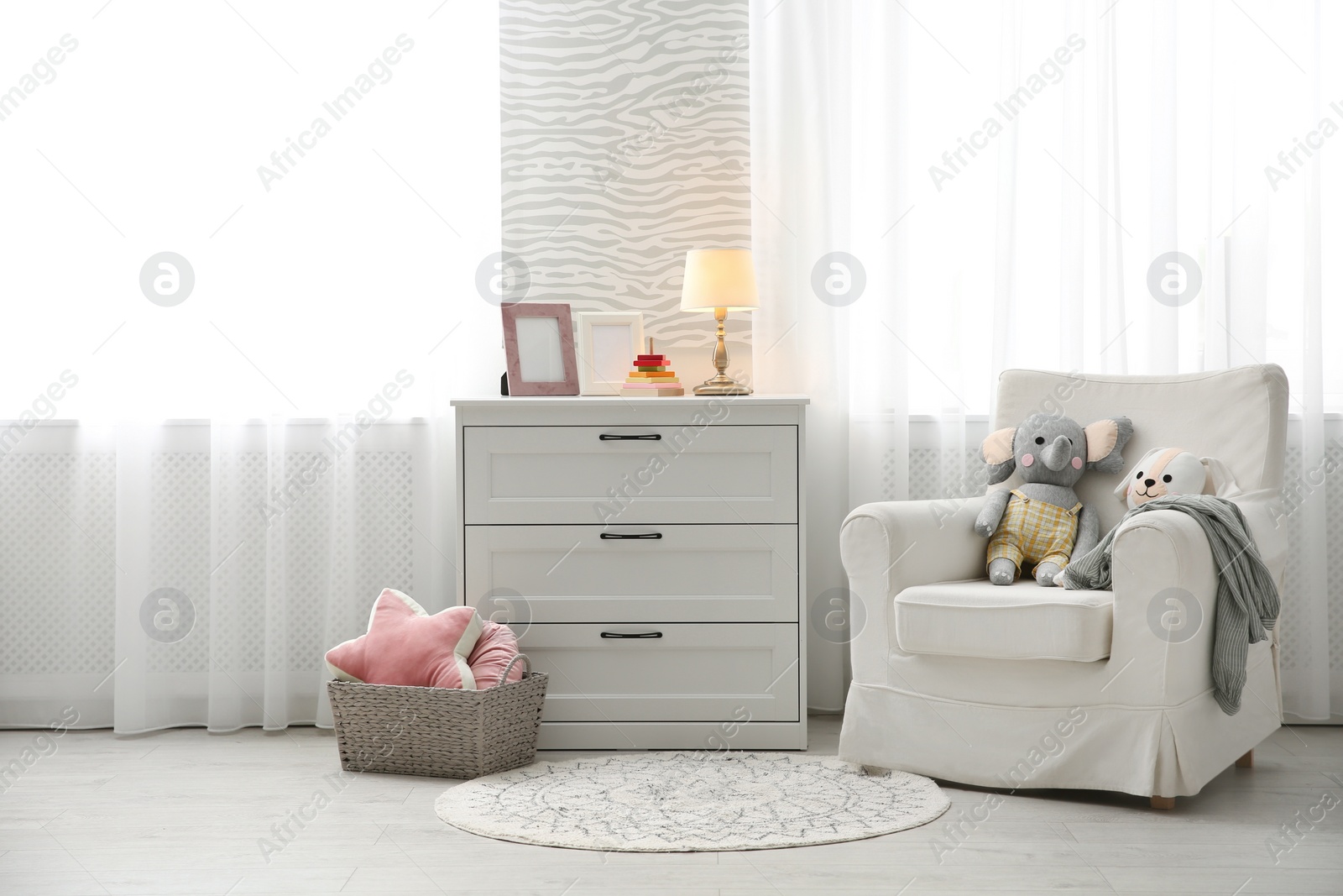 Photo of Comfortable armchair in modern baby room interior