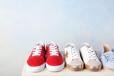 Photo of Stylish new shoes on table against light background