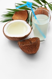 Photo of Composition with coconuts and drink on white background