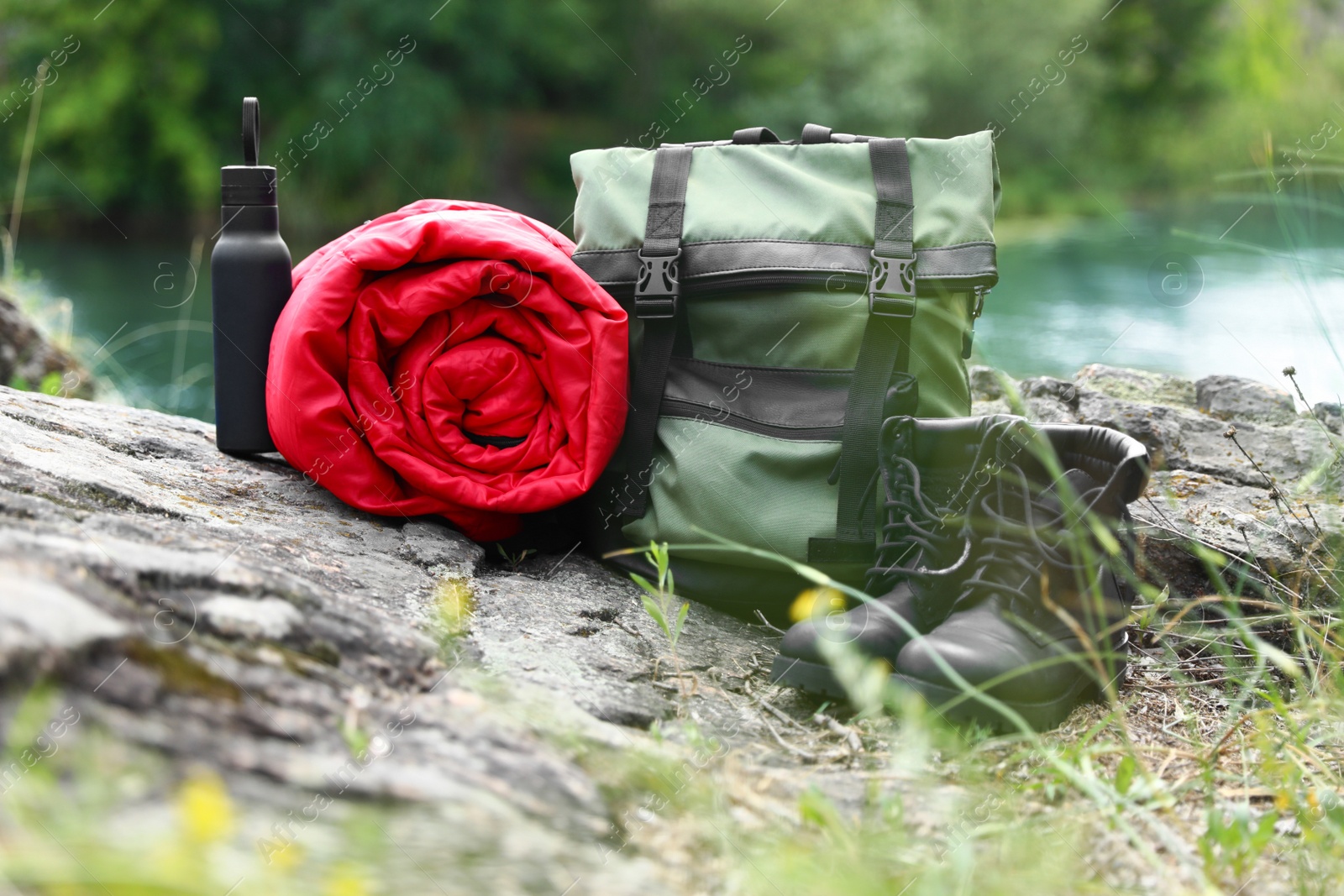 Photo of Rolled sleeping bag and other camping gear outdoors