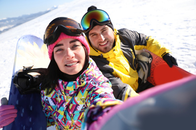 Couple taking selfie on hill. Winter vacation