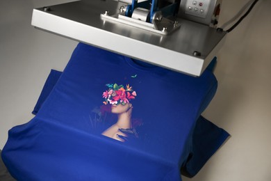 Image of Custom t-shirt. Using heat press to print creative image of woman with beautiful flowers