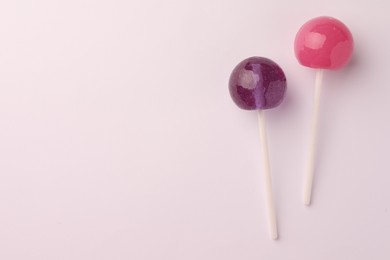 Tasty lollipops on white background, flat lay. Space for text