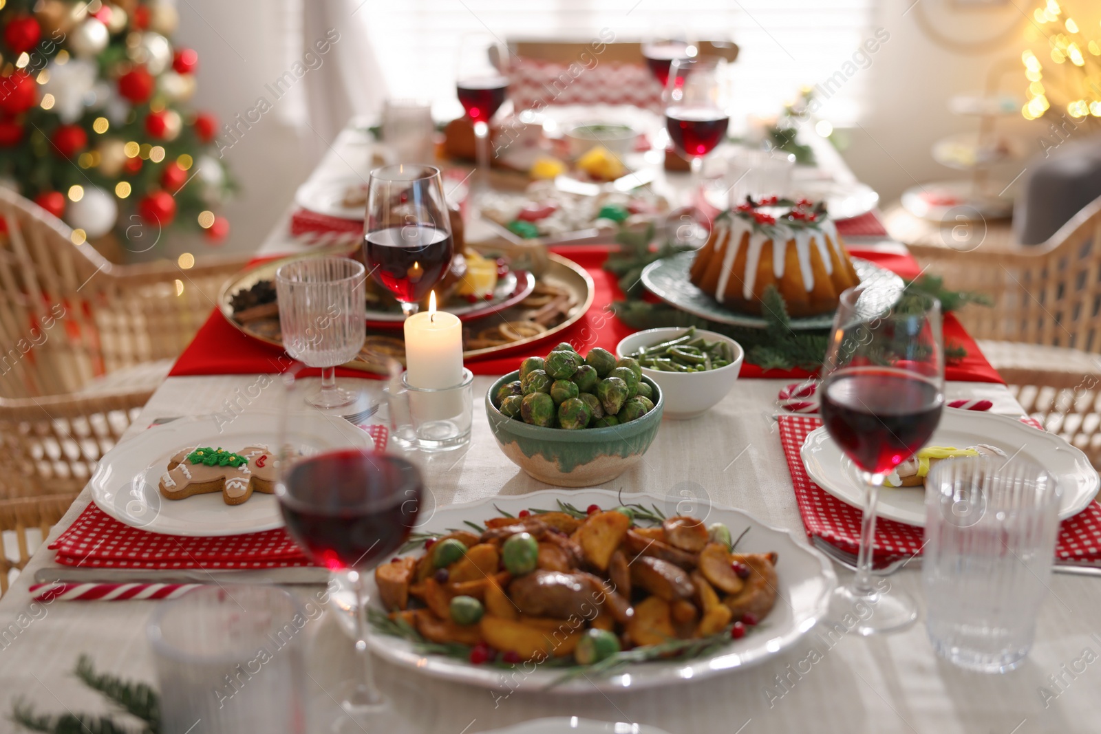 Photo of Festive dinner with delicious food and wine on table indoors. Christmas Eve celebration