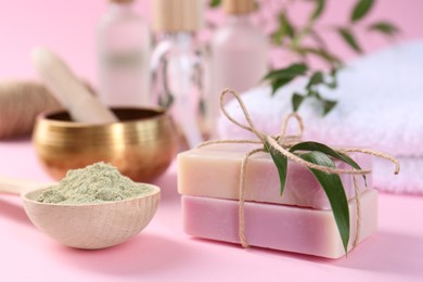 Photo of Retreat concept. Soap bars and spirulina powder on pink background