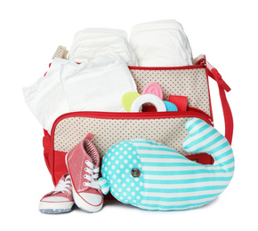 Photo of Maternity bag with disposable diapers and child's accessories on white background