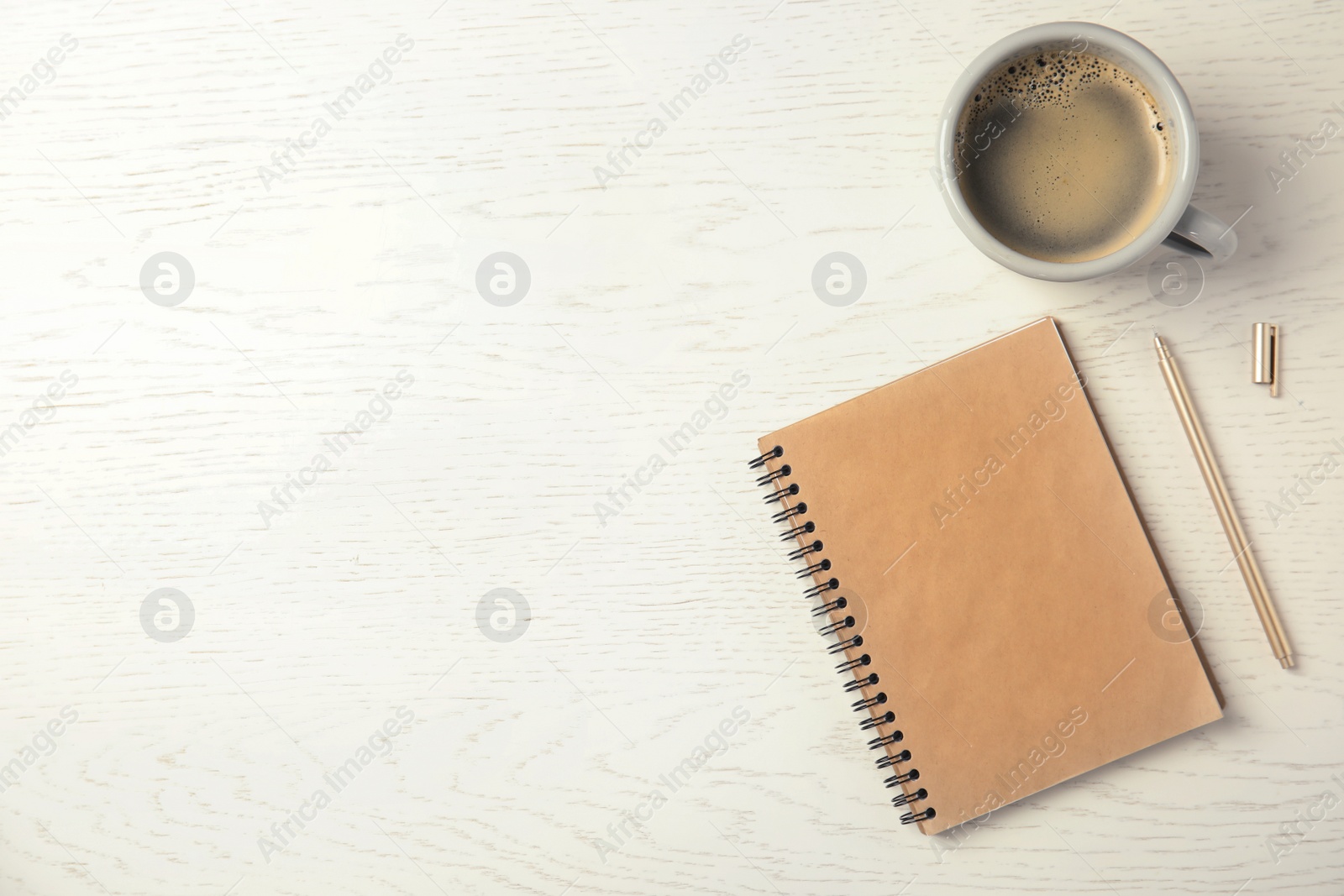 Photo of Notebook and cup of coffee on wooden background, top view with space for text