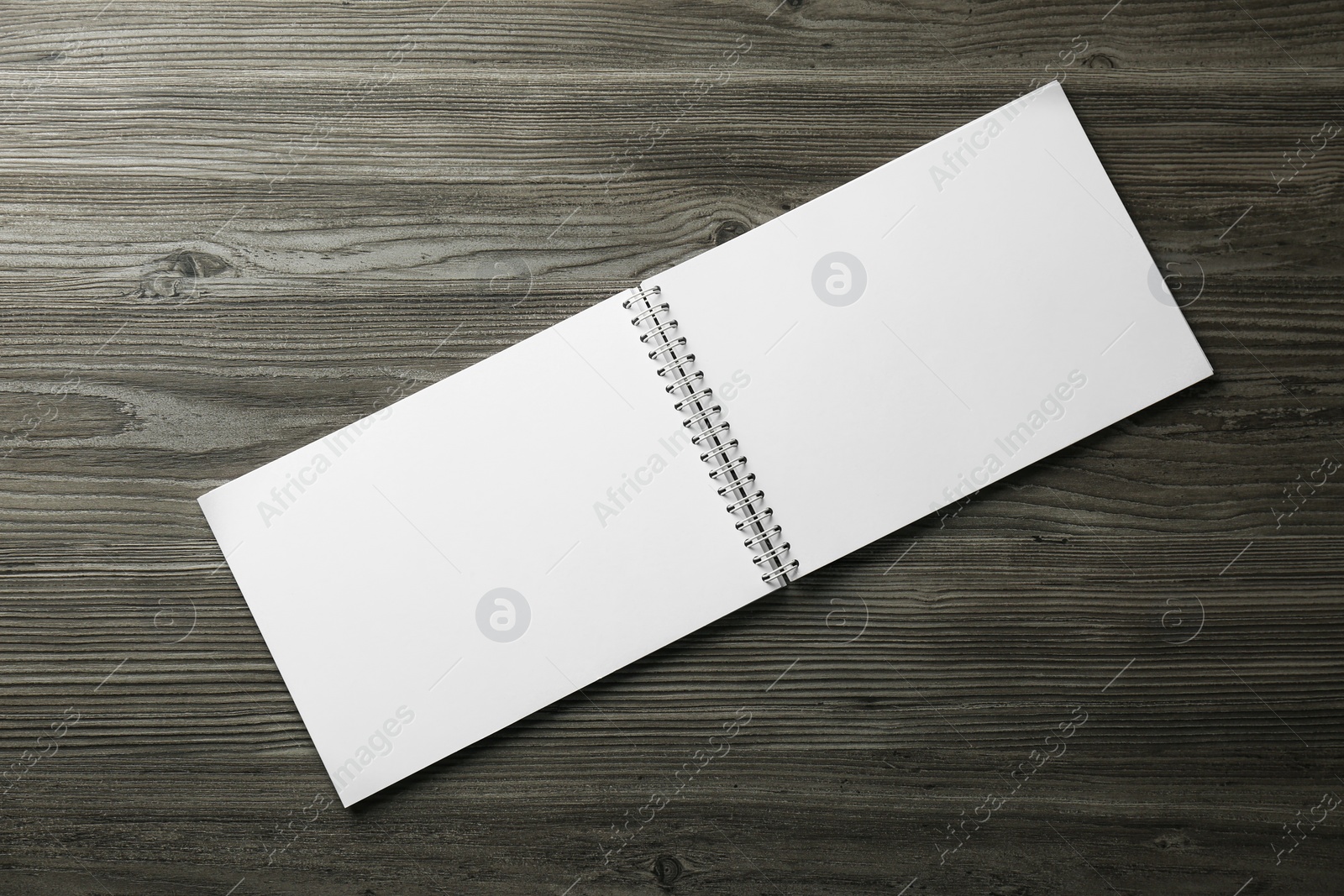 Photo of Blank paper brochure on wooden table, top view. Mockup for design